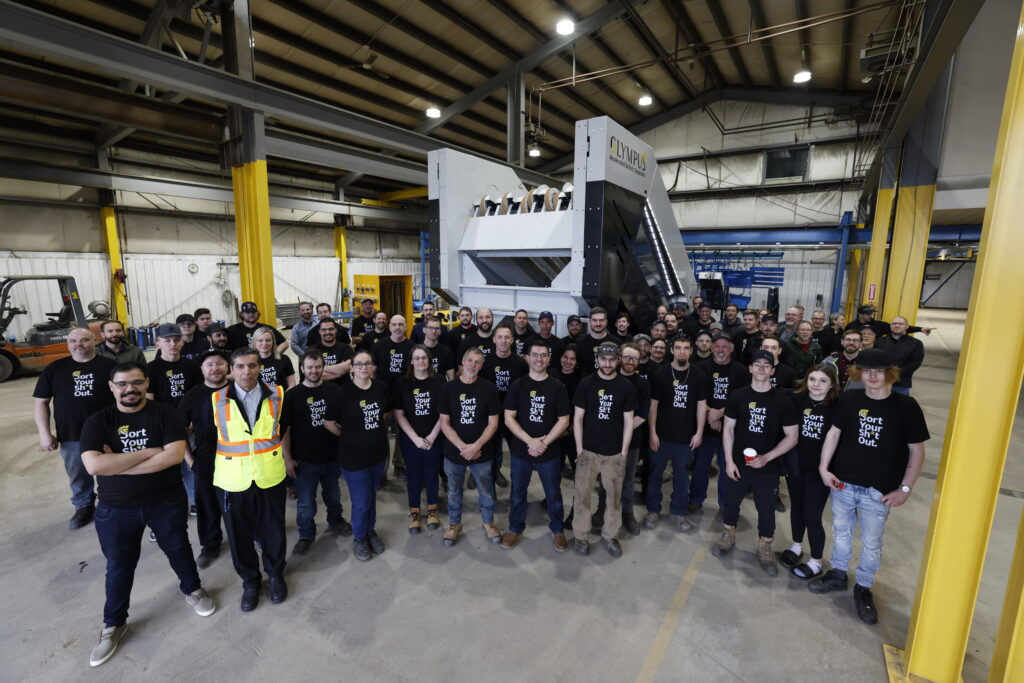 The Sparta Manufacturing team gathered in front of the Olympus Accelerated Ballistic Separator during the company's 50th anniversary celebration.