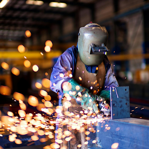 Sparta Manufacturing - Passion. Expertise. Flexibility. | Careers at Sparta Manufacturing | Jobs in New Brunswick Fabricator welding a steel component at Sparta Manufacturing's facility in New Brunswick using precision metal fabrication techniques for recycling systems.