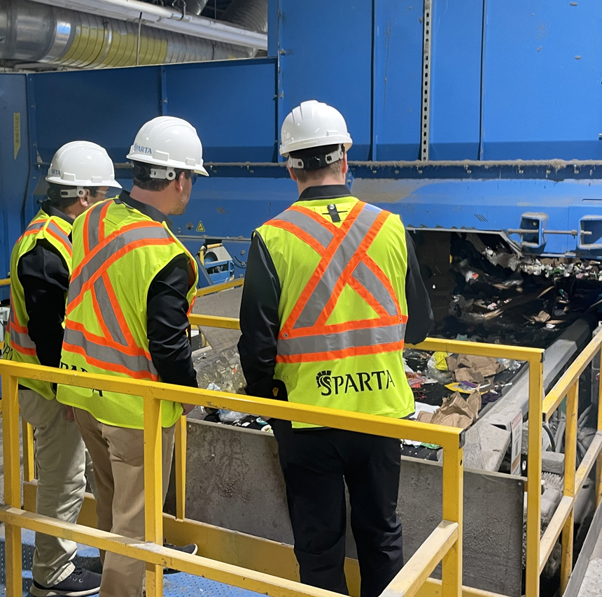 Sparta team members inspecting a recycling system at a material processing facility